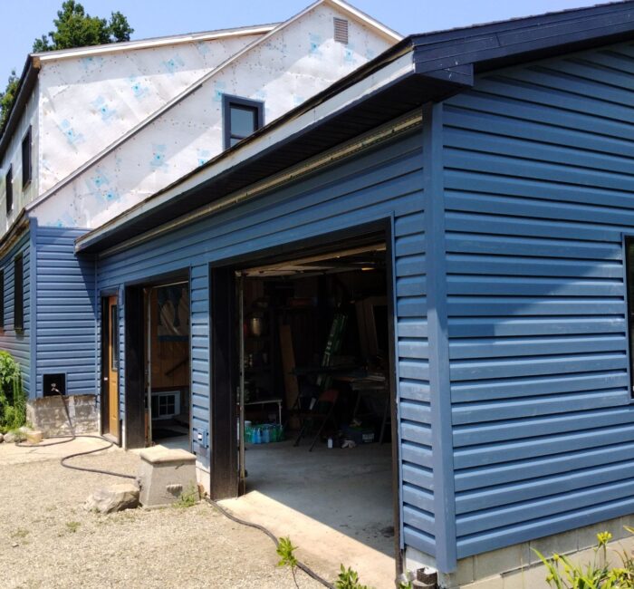 Bright blue vinyl siding installed by Bauer Specialty