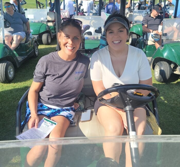 Staff sitting on golf card