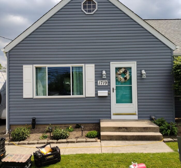 Dark gray/blue siding installed