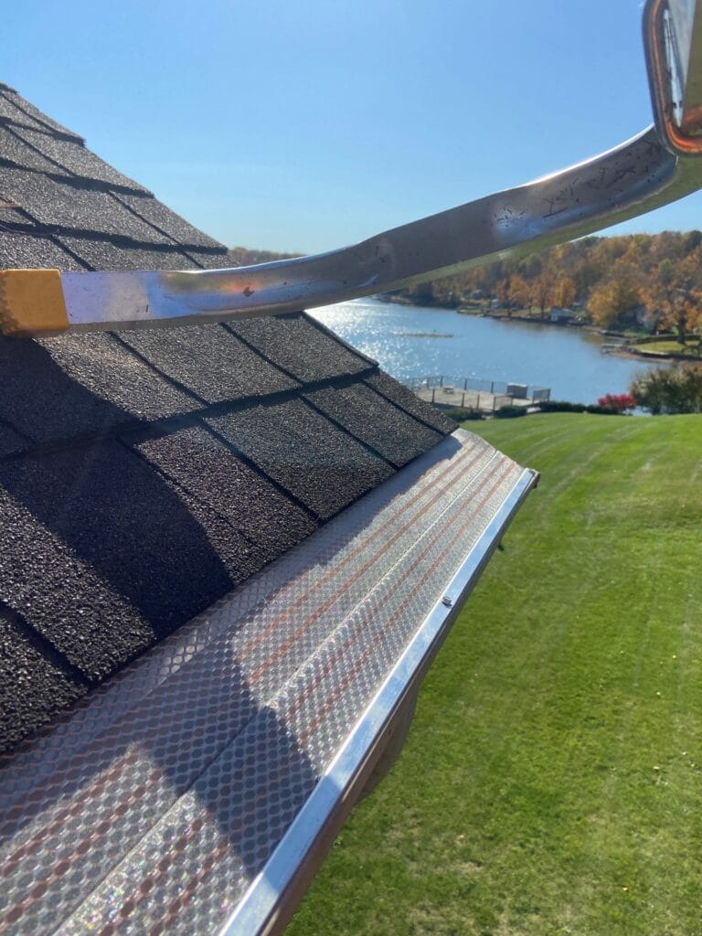 Klean Gutter gutter covers installed with a beautiful lake and fall leaves in the background